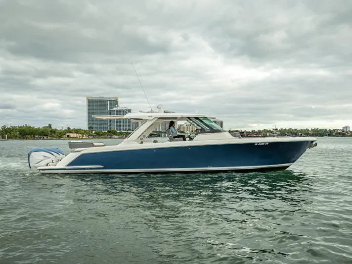  Yacht Photos Pics 2021 Tiara Sport 43 LS boat cruising on a cloudy day.