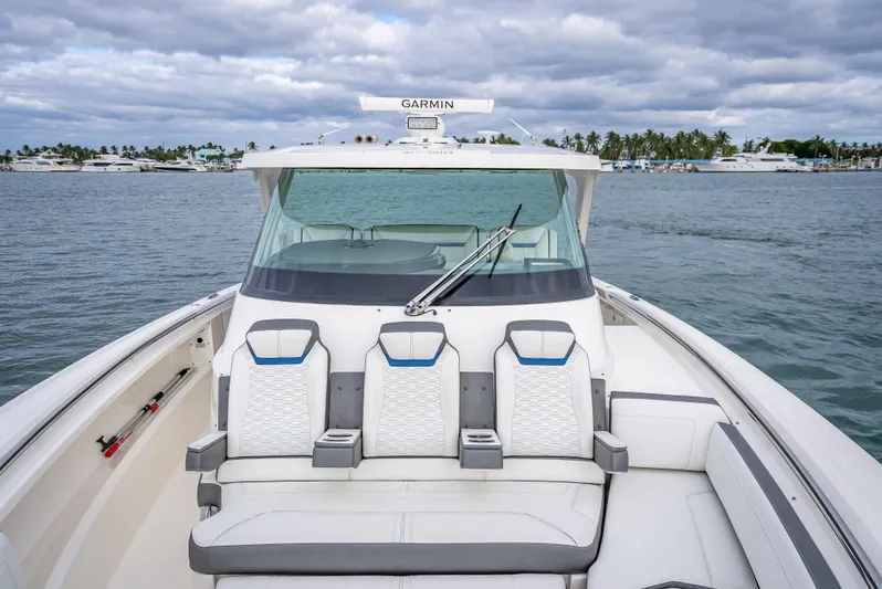  Yacht Photos Pics 2021 Tiara Sport 43 LS boat with seating, on a calm water backdrop.