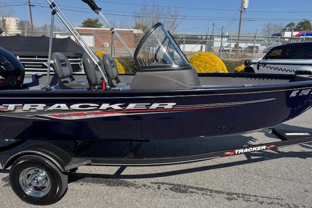 2023 Tracker Pro Guide V-16 WT boat on trailer, parked outdoors.