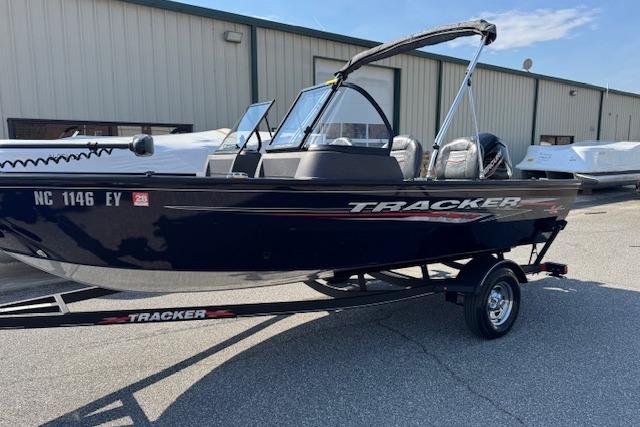 2023 Tracker Pro Guide V-16 WT boat on trailer, parked outdoors.