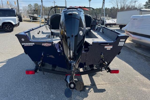 2023 Tracker Pro Guide V-16 WT boat, rear view, parked outdoors.