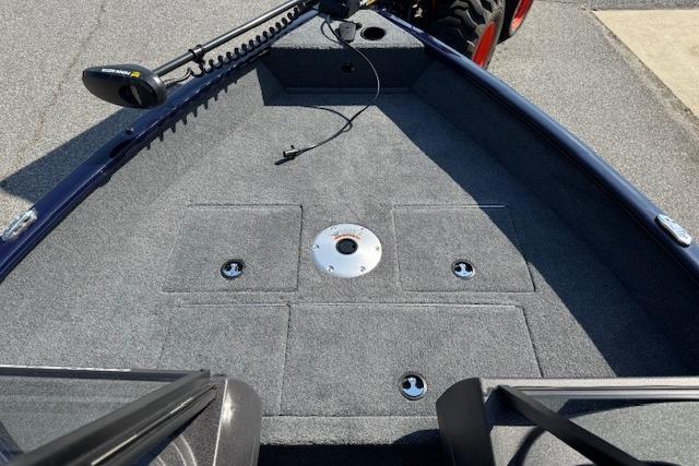 2023 Tracker Pro Guide V-16 WT boat deck with carpeted surface and storage compartments.