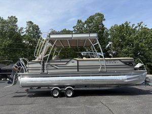 2017 Crest Classic 250L pontoon boat on trailer, parked outdoors.