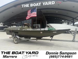 Boat on trailer at The Boat Yard, Marrero, Louisiana, with American flag. Kirk Matherne 1995 model.