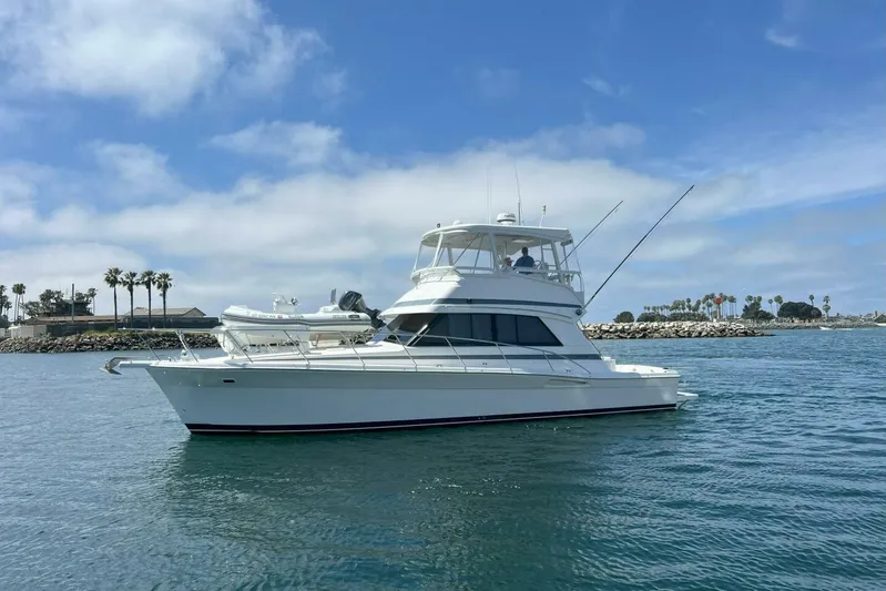 Fortuna Yacht Photos Pics 2002 Riviera 43 Open Flybridge yacht on calm water, clear sky background.