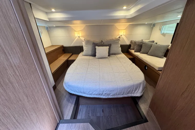  Yacht Photos Pics Luxurious cabin interior of 2018 Beneteau Gran Turismo 46 yacht with cozy bedding and seating.