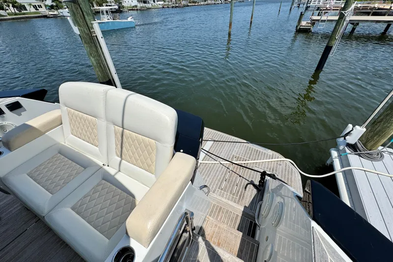  Yacht Photos Pics 2018 Beneteau Gran Turismo 46 yacht with elegant seating, docked by the water.