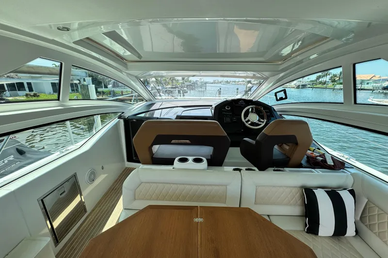  Yacht Photos Pics Interior view of 2018 Beneteau Gran Turismo 46 yacht, featuring helm and seating area.