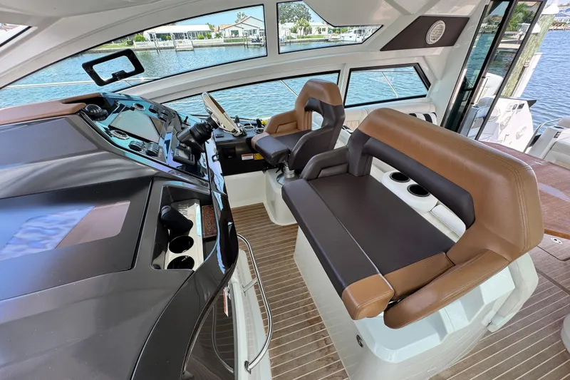  Yacht Photos Pics Interior of 2018 Beneteau Gran Turismo 46 yacht with modern helm and seating.