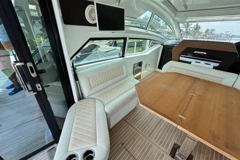  Yacht Photos Pics Luxurious interior of 2018 Beneteau Gran Turismo 46 yacht with elegant seating and wooden table.