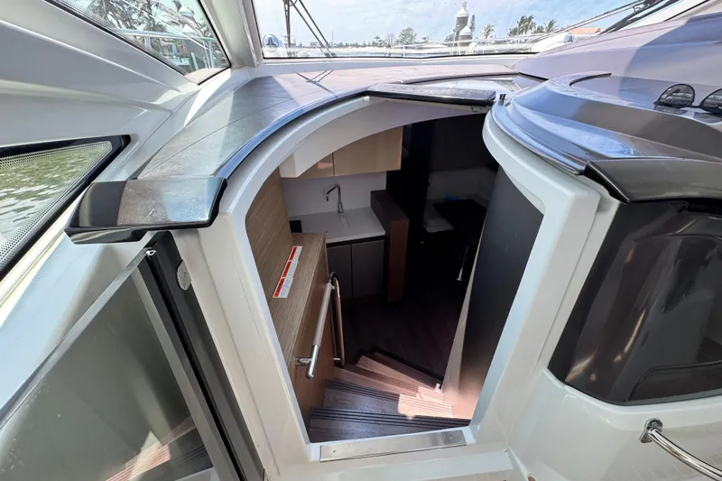  Yacht Photos Pics Interior view of 2018 Beneteau Gran Turismo 46 yacht, showcasing stairs and cabin entrance.