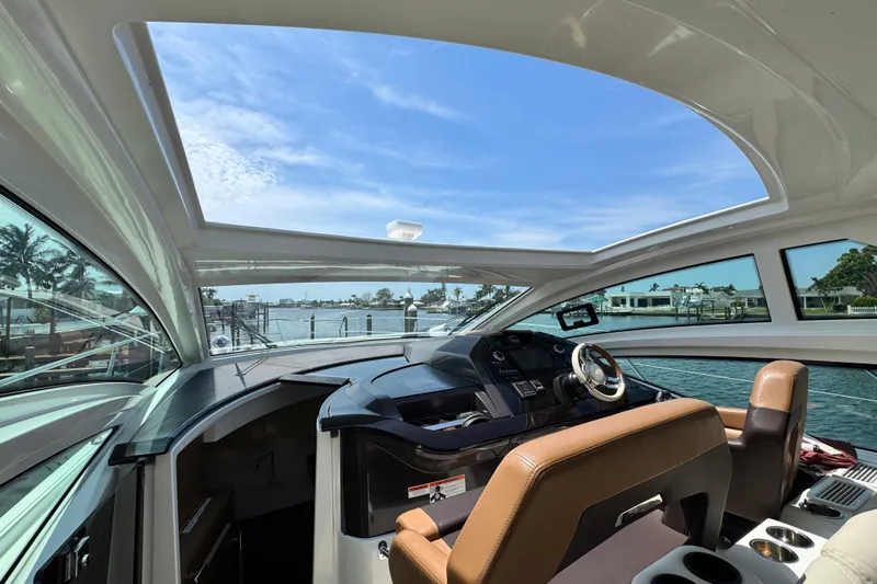  Yacht Photos Pics Interior view of 2018 Beneteau Gran Turismo 46 yacht with open sunroof and waterfront scenery.