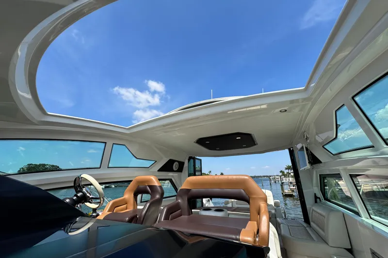  Yacht Photos Pics Interior view of 2018 Beneteau Gran Turismo 46 yacht with open sunroof and luxurious seating.