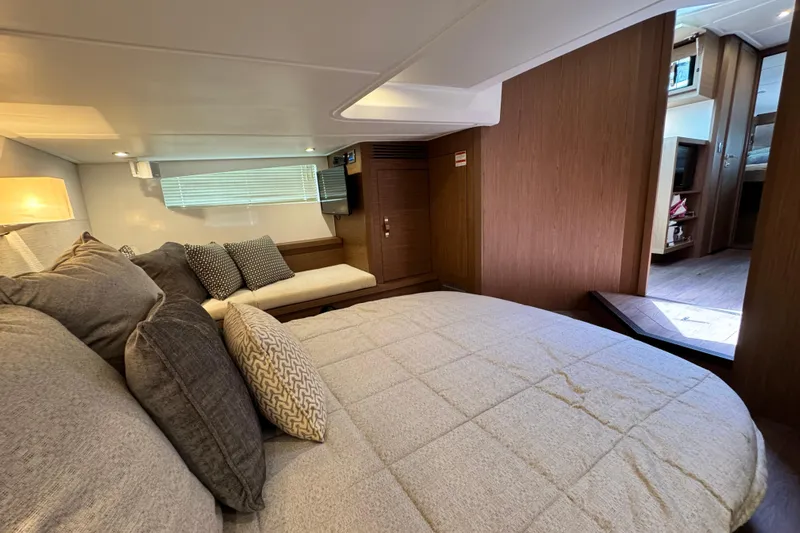  Yacht Photos Pics Luxurious interior of 2018 Beneteau Gran Turismo 46 yacht with cozy bedding and modern decor.