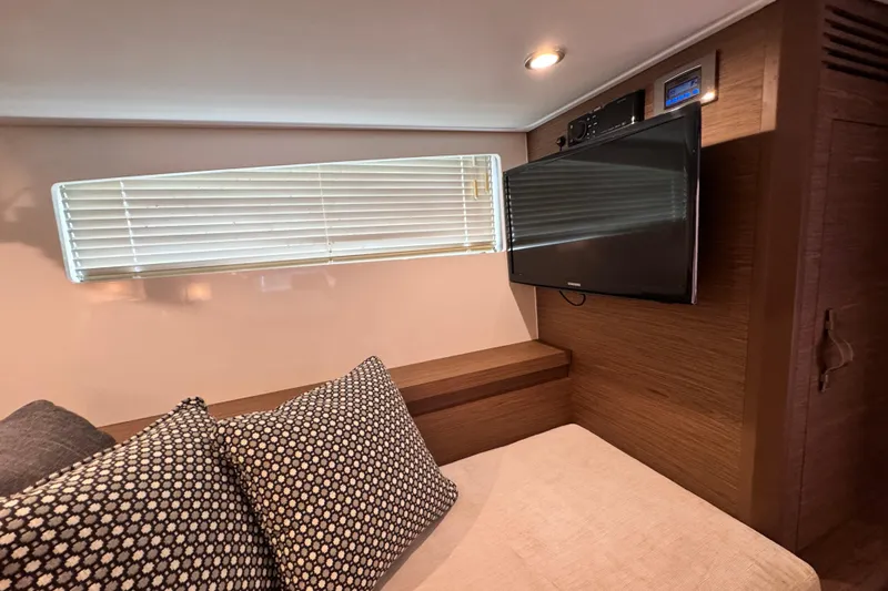  Yacht Photos Pics Interior of 2018 Beneteau Gran Turismo 46 yacht with TV, window blinds, and cozy seating.