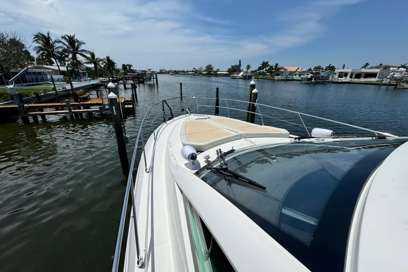  Yacht Photos Pics 2018 Beneteau Gran Turismo 46 yacht docked in a scenic waterfront location.