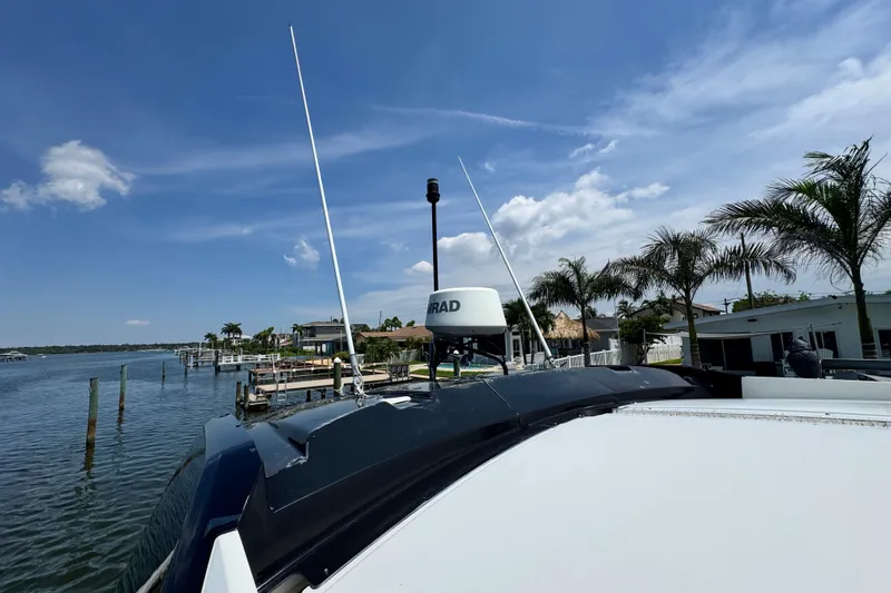  Yacht Photos Pics 2018 Beneteau Gran Turismo 46 yacht docked by palm trees under a clear blue sky.