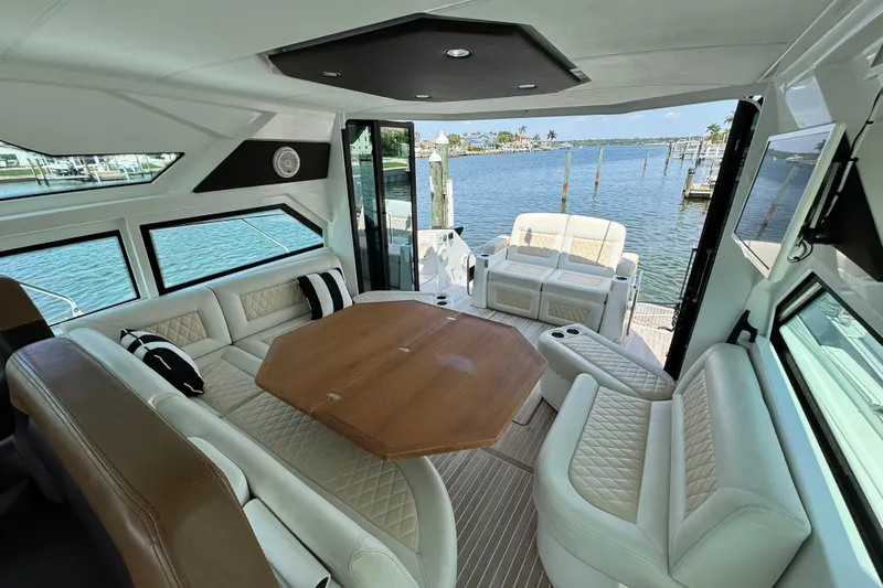  Yacht Photos Pics Luxurious interior of 2018 Beneteau Gran Turismo 46 yacht with elegant seating and scenic water view.