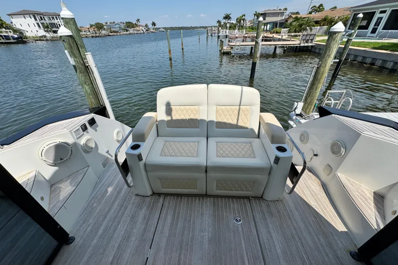  Yacht Photos Pics Luxury seating on 2018 Beneteau Gran Turismo 46 yacht, docked by waterfront homes.