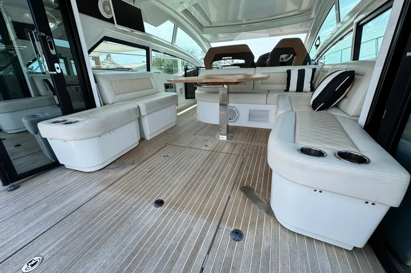  Yacht Photos Pics Luxurious interior of 2018 Beneteau Gran Turismo 46 yacht with elegant seating and table.