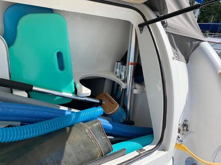  Yacht Photos Pics Storage compartment of a 2005 Formula 34 PC boat with cleaning supplies and pool noodles.