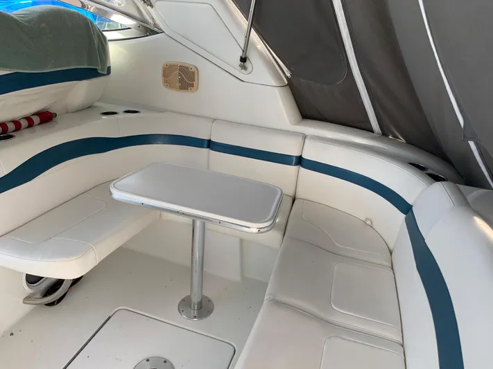  Yacht Photos Pics 2005 Formula 34 PC boat interior with white and blue seating and table.