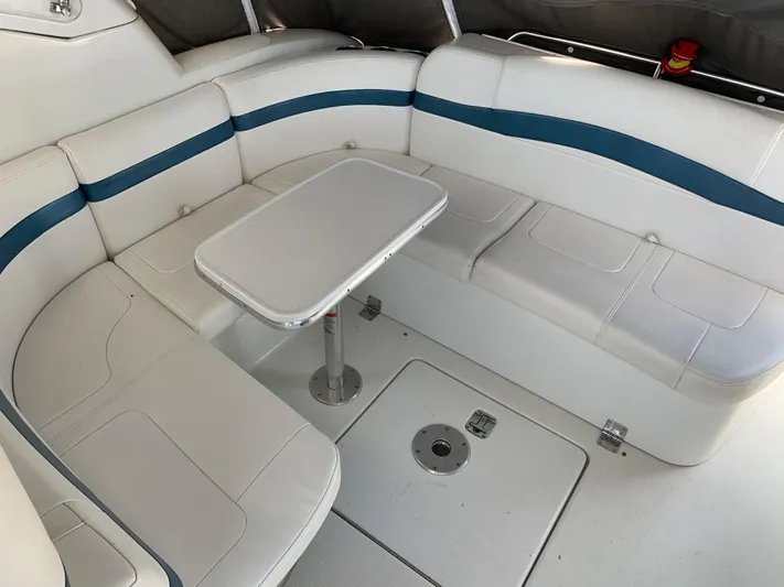  Yacht Photos Pics 2005 Formula 34 PC boat interior with white and blue seating and table.