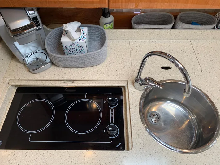  Yacht Photos Pics 2005 Formula 34 Performance Cruiser kitchen with stove, sink, and countertop accessories.