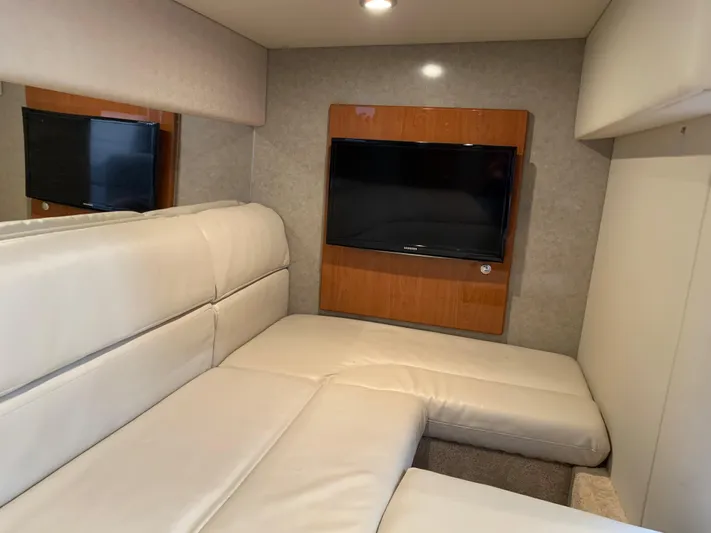  Yacht Photos Pics 2005 Formula 34 Performance Cruiser interior with beige seating and wall-mounted TV.