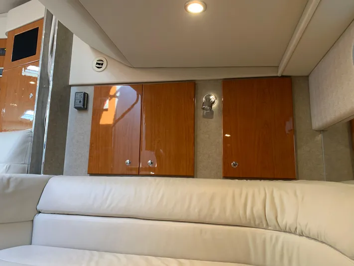  Yacht Photos Pics Interior of 2005 Formula 34 Performance Cruiser with wood cabinets and white seating.