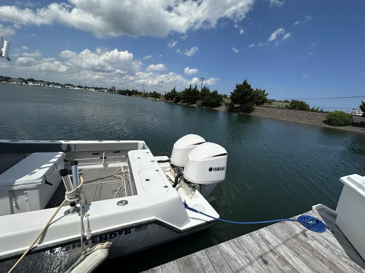  Yacht Photos Pics 2004 Contender 31 Fish Around boat docked, featuring Yamaha engines, under a partly cloudy sky.