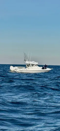  Yacht Photos Pics 2004 Contender 31 Fish Around boat on open sea under clear sky.