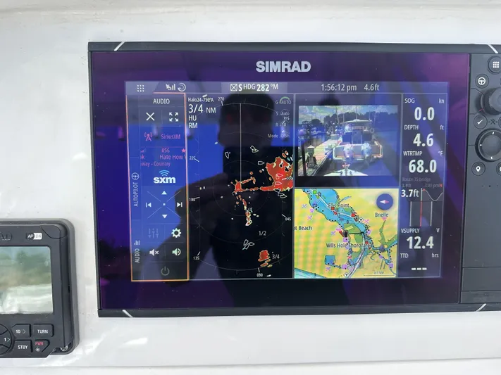  Yacht Photos Pics Simrad marine display on 2004 Contender 31 Fish Around, showing navigation and radar data.