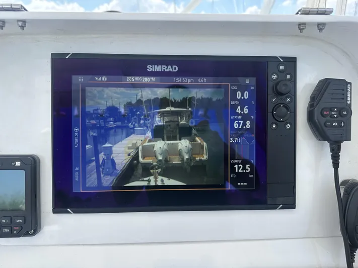  Yacht Photos Pics Simrad marine display on 2004 Contender 31 Fish Around boat, showing navigation and depth data.