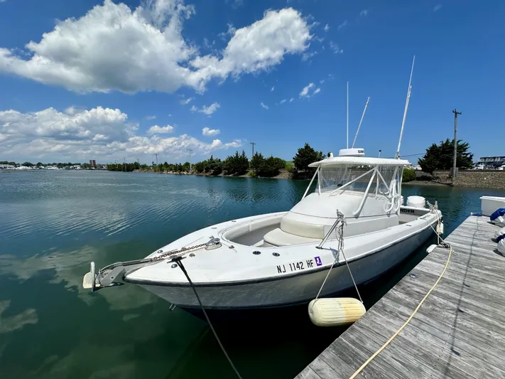  Yacht Photos Pics 2004 Contender 31 Fish Around boat docked on a sunny day with blue skies.