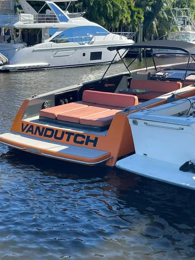  Yacht Photos Pics 2013 VanDutch 40 Open Bow yacht with orange accents docked in a marina.