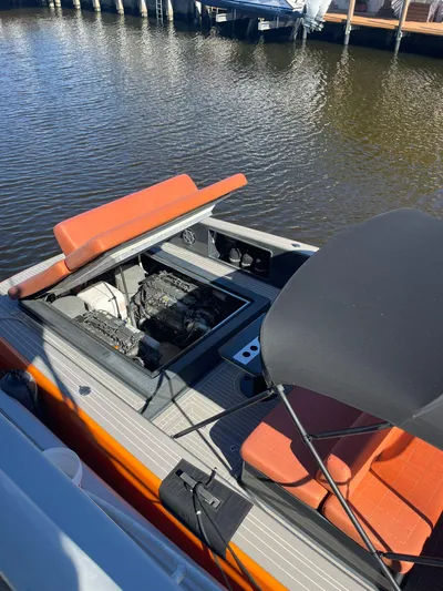 Yacht Photos Pics 2013 VanDutch 40 Open Bow boat with open engine compartment, docked on calm water.