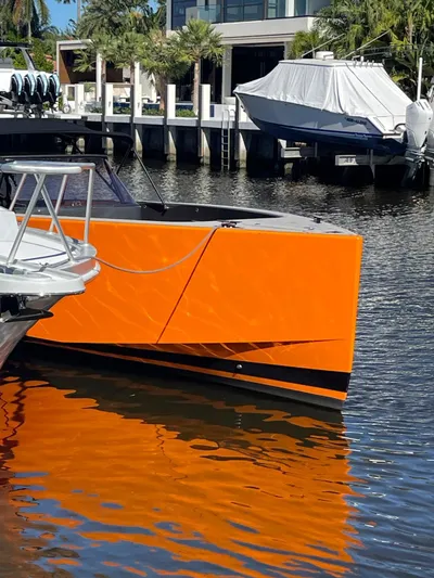  Yacht Photos Pics Orange 2013 VanDutch 40 Open Bow yacht docked in a marina.