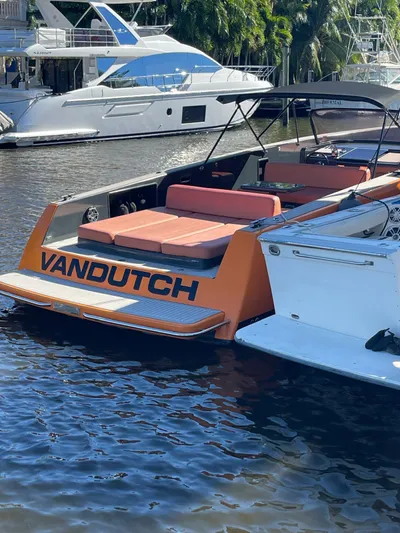  Yacht Photos Pics 2013 VanDutch 40 Open Bow yacht with orange accents docked in marina.