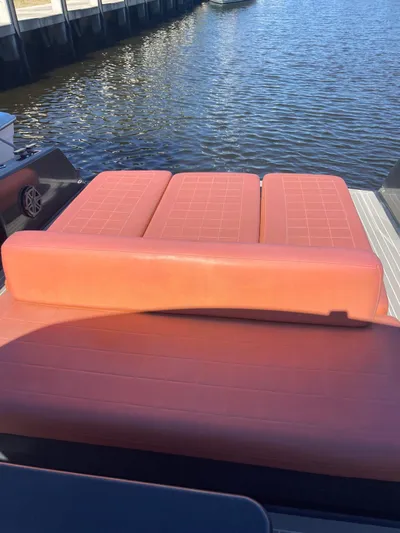  Yacht Photos Pics 2013 VanDutch 40 Open Bow with orange seating, docked by the water.