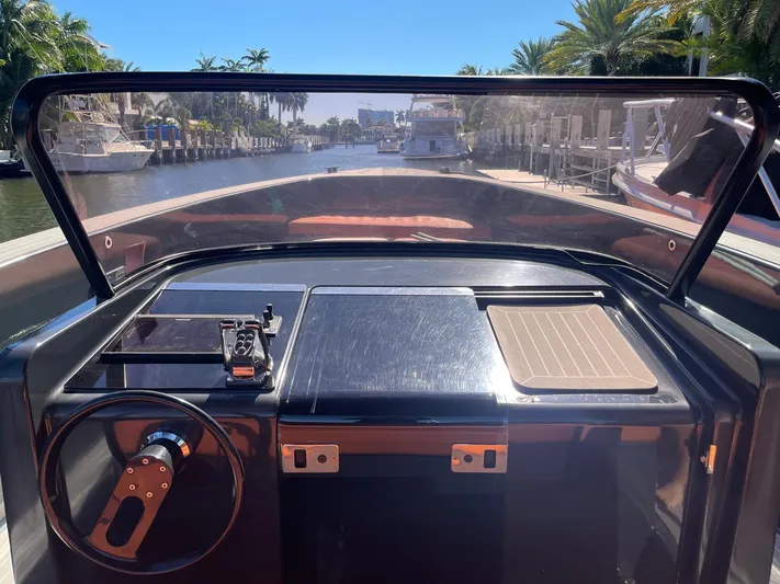  Yacht Photos Pics 2013 VanDutch 40 Open Bow yacht cockpit with sleek design, steering wheel, and waterfront view.