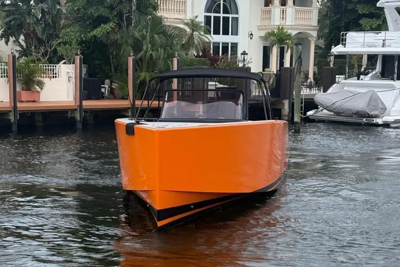  Yacht Photos Pics Orange 2013 VanDutch 40 Open Bow boat docked near waterfront mansion.