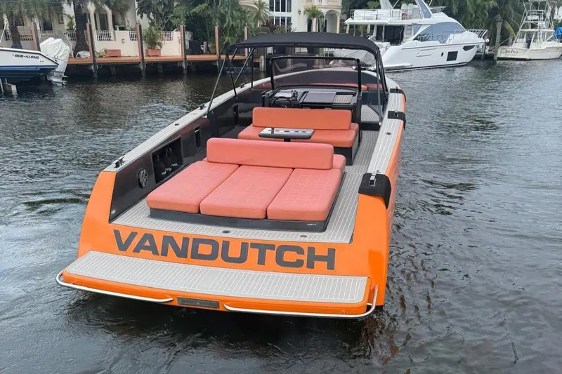  Yacht Photos Pics 2013 VanDutch 40 Open Bow boat with orange exterior, docked on calm water.