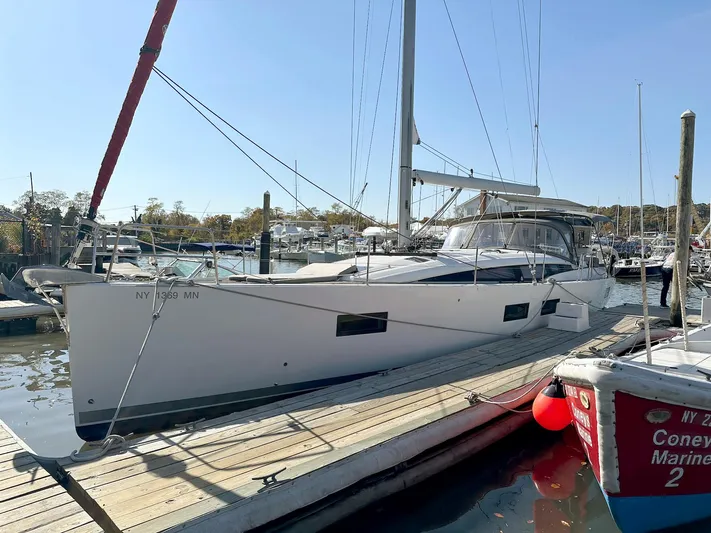  Yacht Photos Pics 2018 Jeanneau 51 sailboat docked at marina, clear sky, side view.