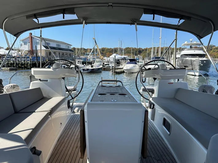  Yacht Photos Pics 2018 Jeanneau 51 yacht interior with dual steering wheels, docked at a marina.