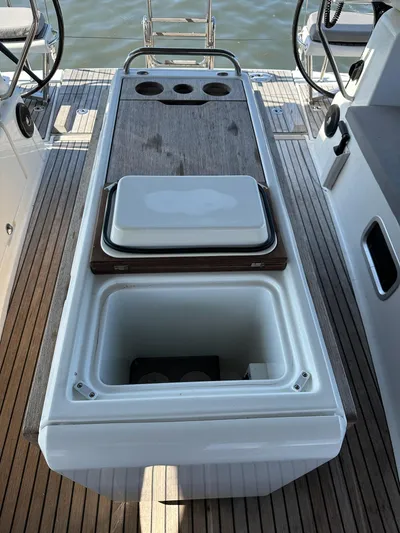  Yacht Photos Pics 2018 Jeanneau 51 yacht deck with open storage compartment and steering wheels.