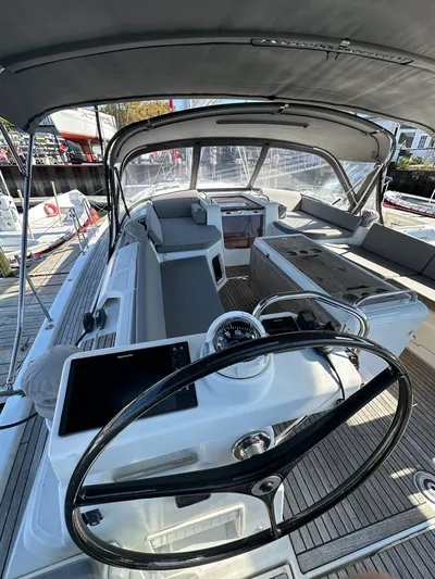  Yacht Photos Pics 2018 Jeanneau 51 yacht cockpit with steering wheel, modern navigation, and spacious seating.
