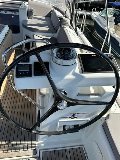  Yacht Photos Pics 2018 Jeanneau 51 yacht helm with navigation instruments and steering wheel.