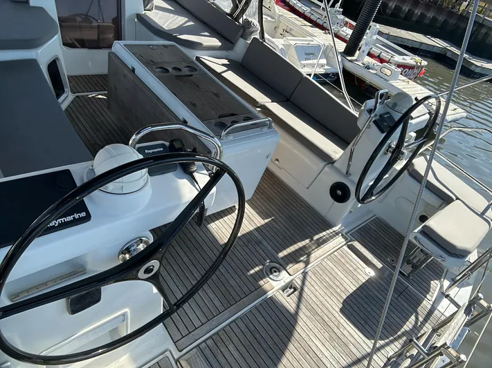  Yacht Photos Pics 2018 Jeanneau 51 yacht cockpit with dual steering wheels and seating area.