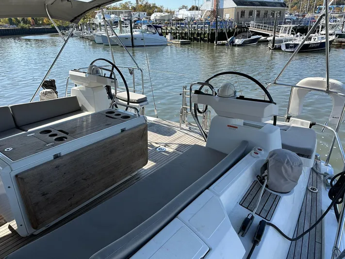  Yacht Photos Pics 2018 Jeanneau 51 sailboat cockpit with dual steering wheels, docked at a marina.